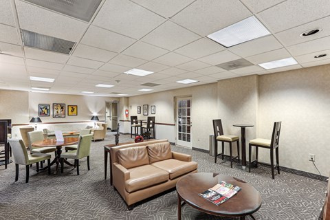 A conference room with a table, chairs, and a couch.